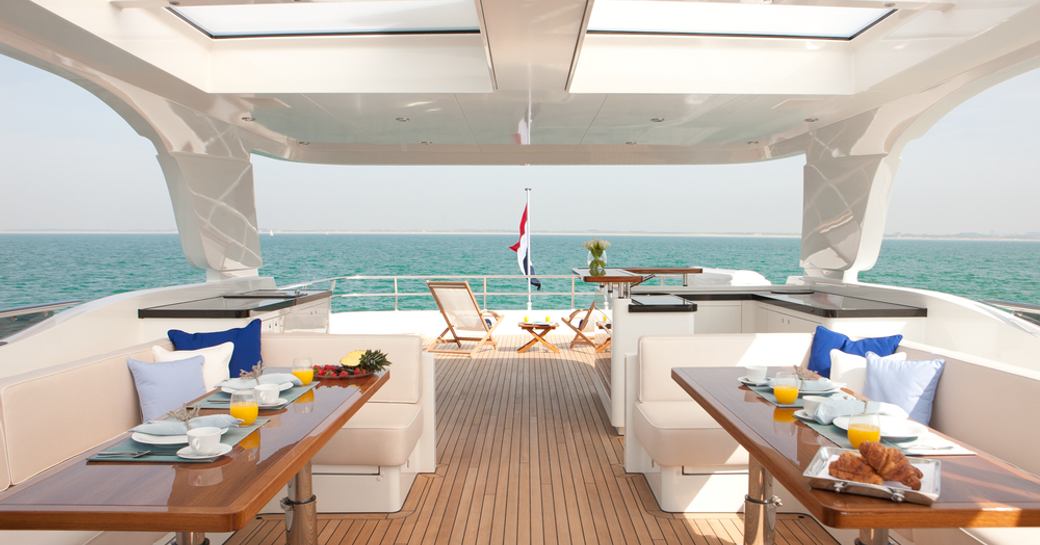 sundeck of superyacht firefly with dining and seating