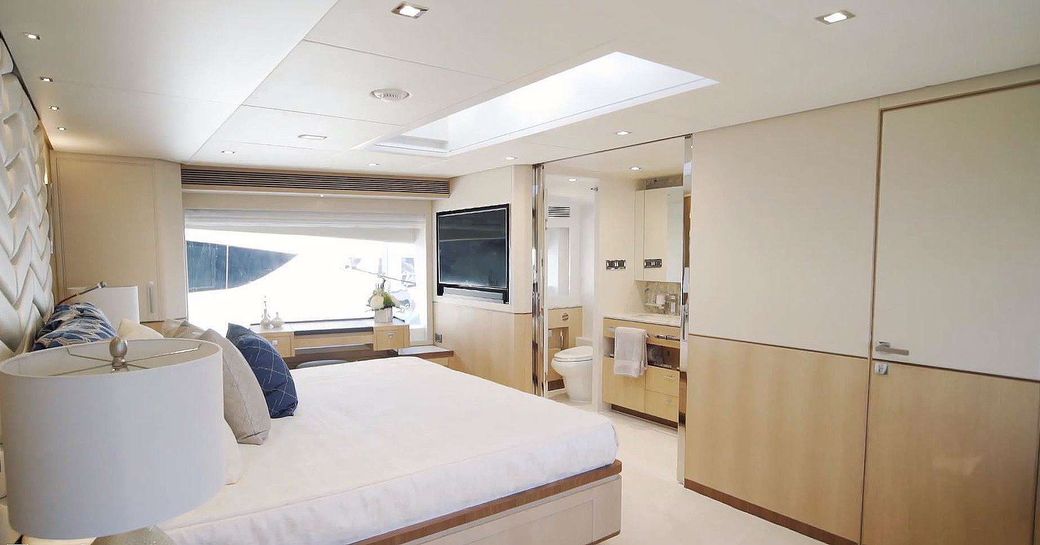 Main cabin on motor yacht Aqua Life with flatscreen TV and ensuite visible