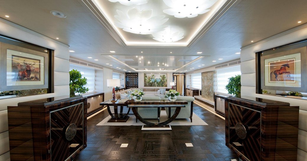 the luxurious main salon of superyacht scorpion with her black onyx cabinets and light upholstery 