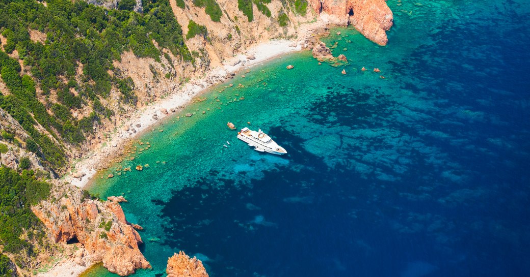 motor yacht in turquoise bay in Corsica, France