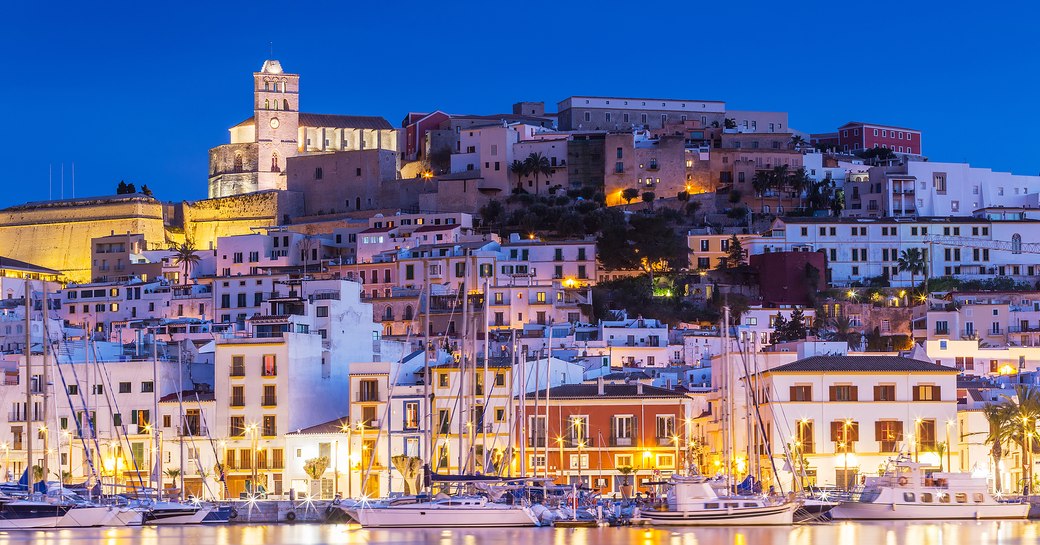 Glowing Ibiza marina with backdrop of colorful houses