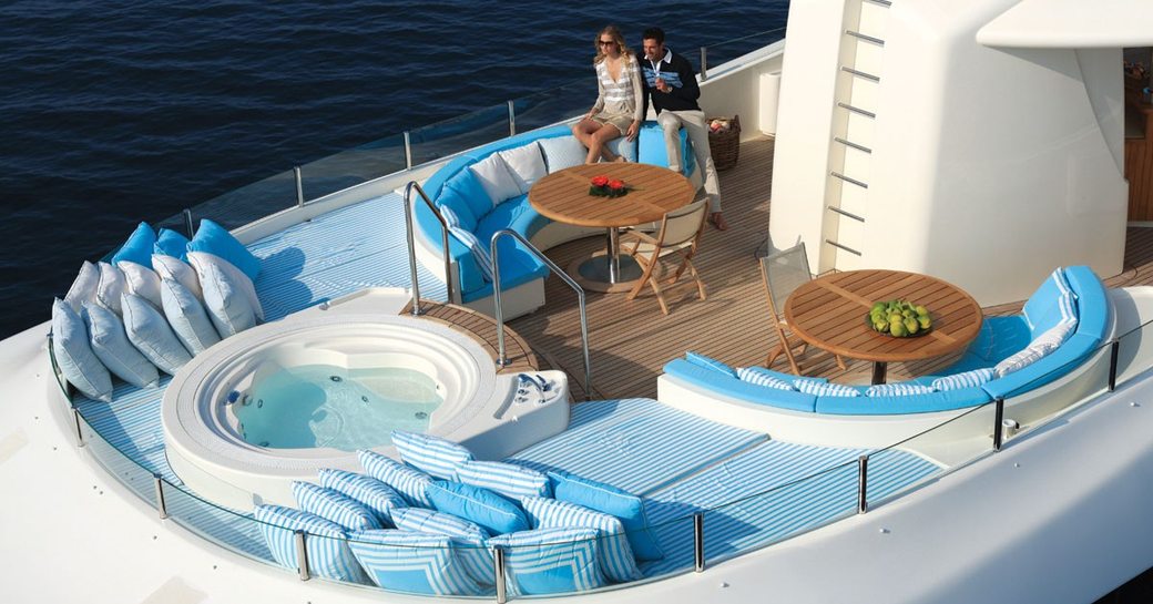 charter guests lounge on the sundeck of motor yacht HANA