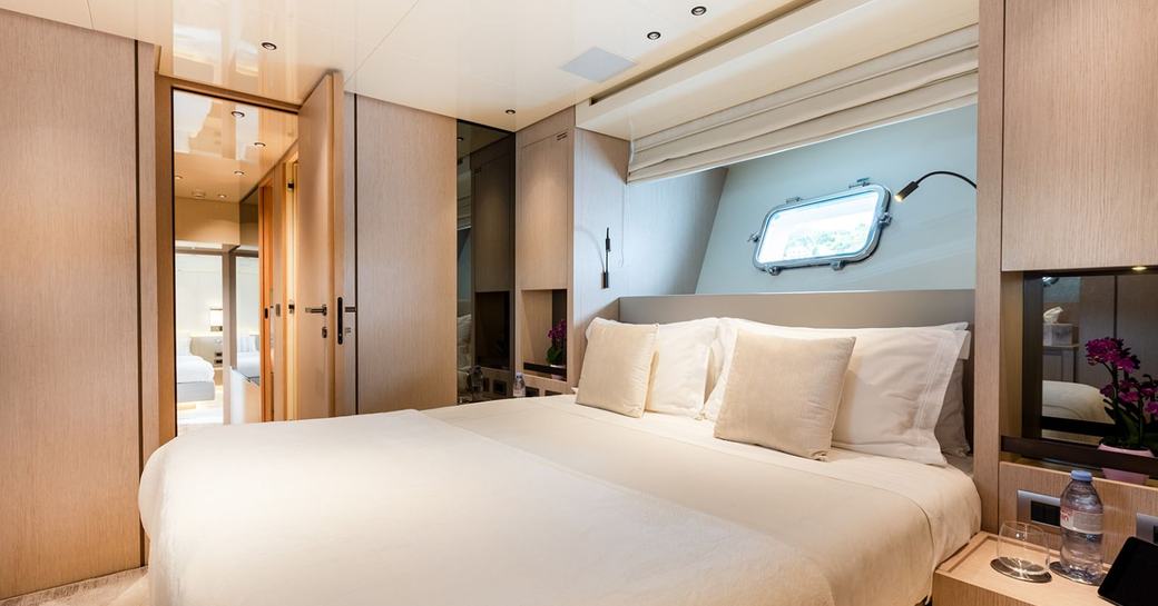 Master cabin onboard boat charter CLOUD IX, central berth with a nightstand either side