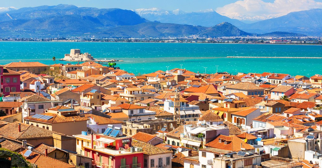Overview of rooftops in Nafplion, Greece. Sea visible over rooftops.