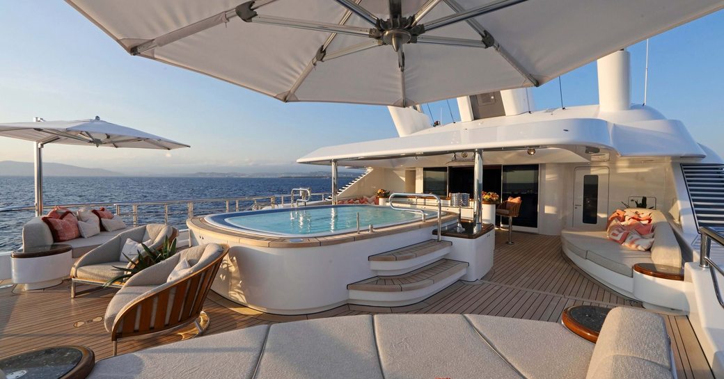 Overview of the sun deck onboard private charter yacht GIGIA, with a central Jacuzzi