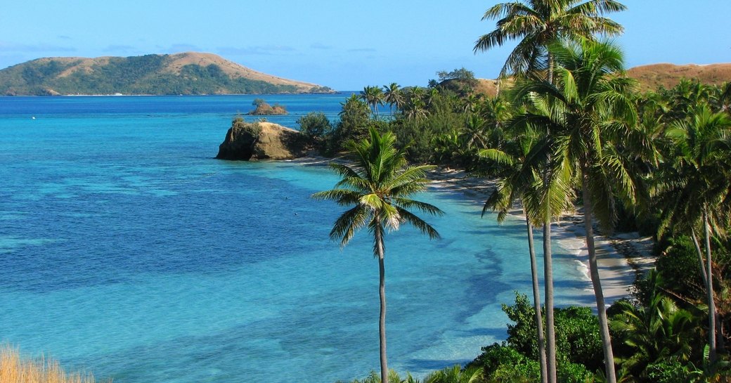 Coastline of Yasawa Island with palm trees in Fiji