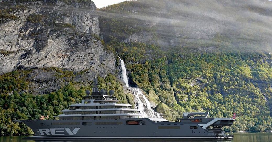 Explorer vessel REV against the backdrop of green hills and waterfall