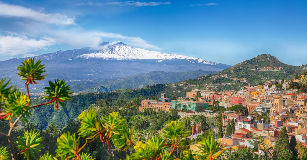 Mount Etna in the distance on Sicily with Taormina in the foreground