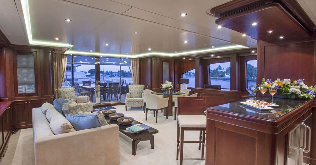 interiors of luxury benetti yacht pure bliss, with main salon in foreground and bar area adjacent