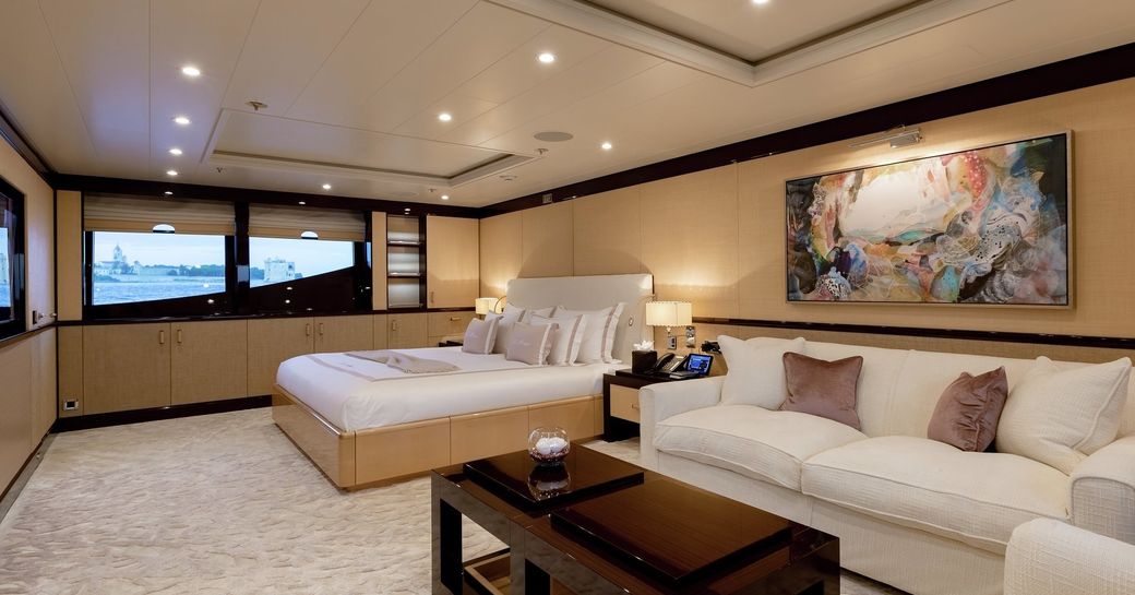 master suite with large bed and sofa on board luxury yacht La Mirage 