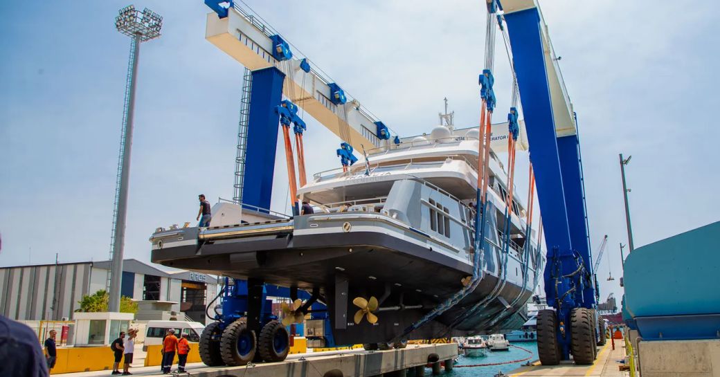 Aft view of charter yacht THANUJA being lifted on a crane 