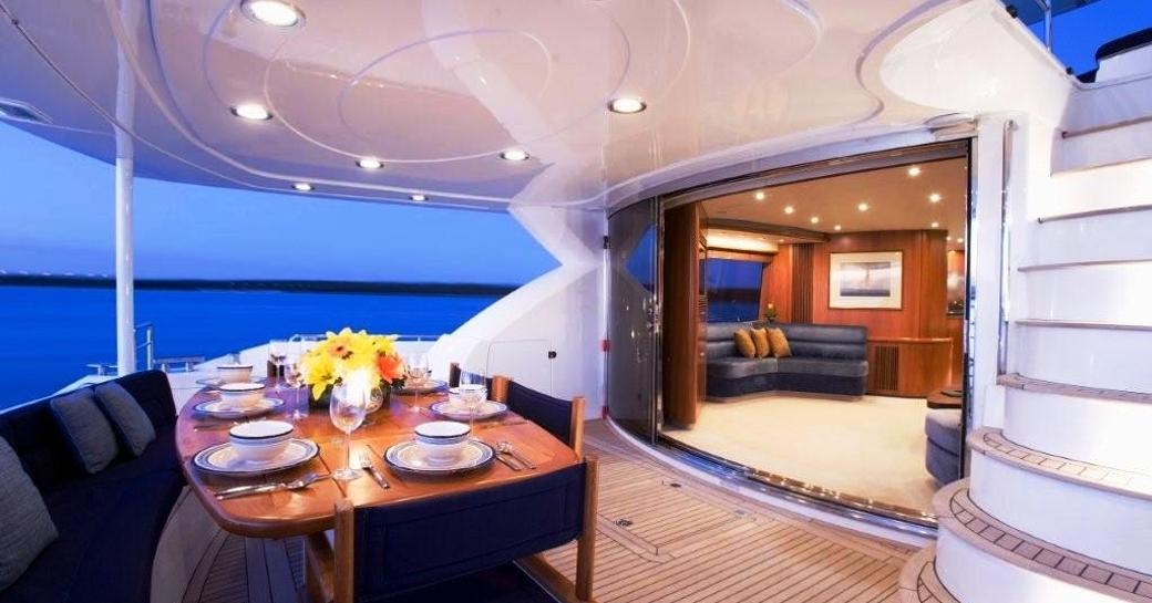 main aft deck alfresco dining table on board superyacht ALANI 