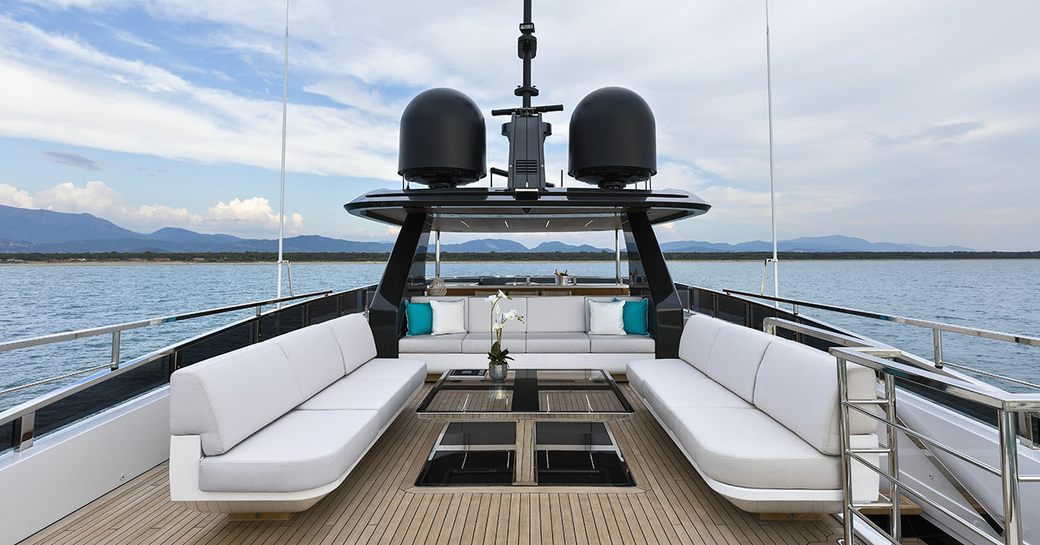 Sun deck onboard boat charter SANCTUARY with white bench seating