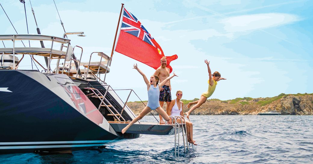 Charter guests jump off the aft deck of a foreign-flagged sailing yacht in the USA