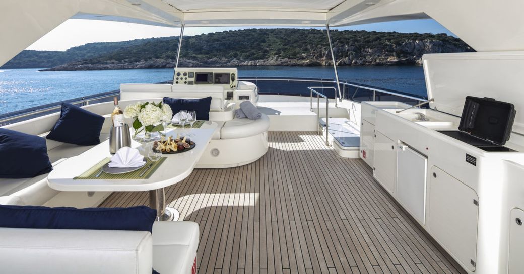shaded seating area with table and grill on board superyacht ASTARTE  