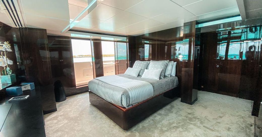 Elegant cabin on superyacht OCULUS with large bed and doors to patio