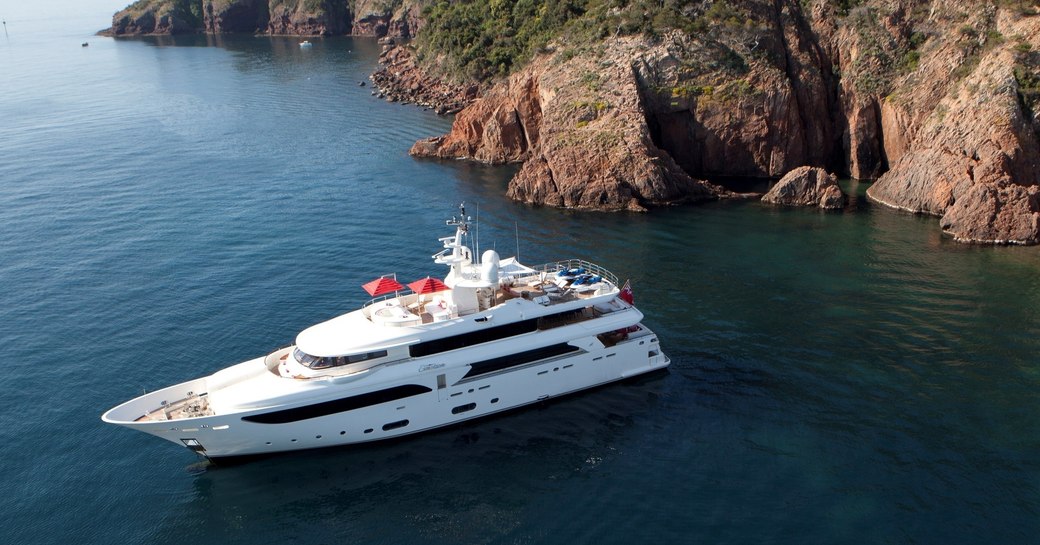 Superyacht EMOTION sat at-anchor just off the coast