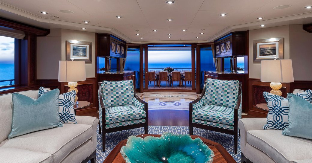 lounge area in the main salon of charter yacht AVALON with view out onto aft deck
