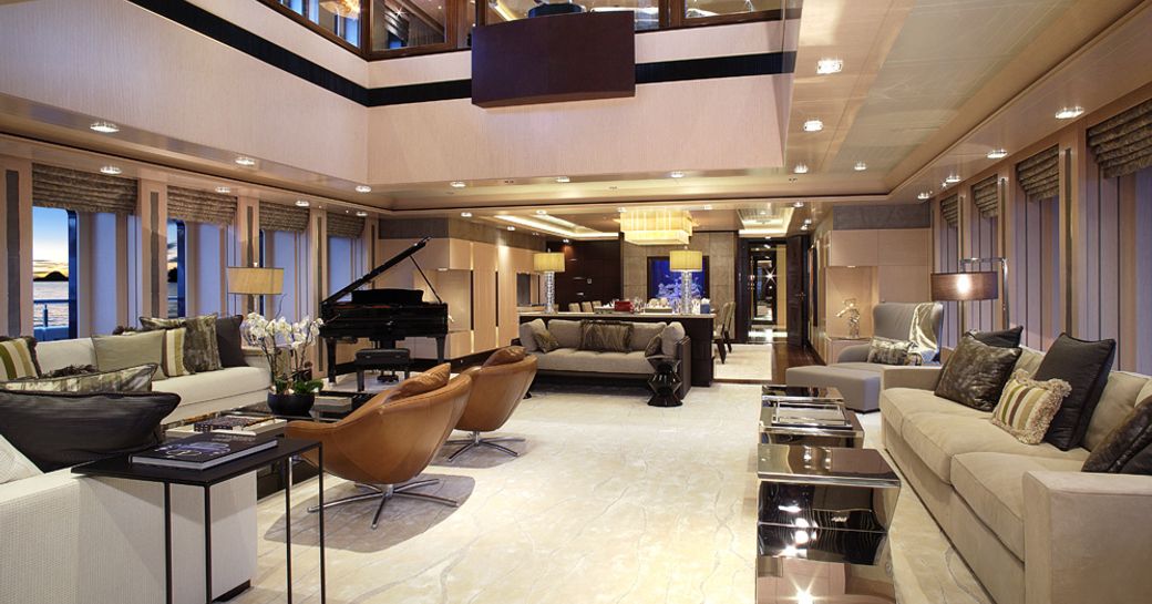 Main salon on superyacht HONOR, with atrium design and lavish interior styling