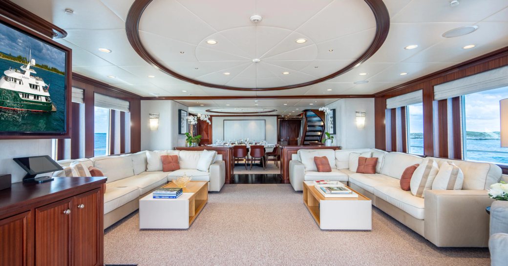 Overview of the main salon onboard charter yacht ZEXPLORER, spacious lounge area with wide windows to starboard
