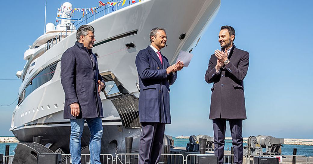 Superyacht DRAGON at her launch, with men from shipyards in front of her