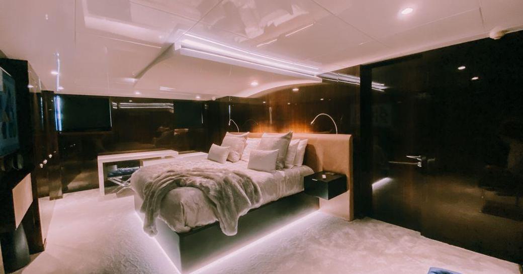 Large cabin on superyacht OCULUS with hushed lighting from under bed