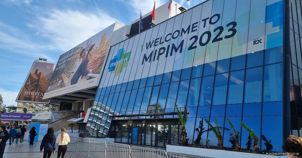 Entrance to MIPIM marked with welcome sign and barriers