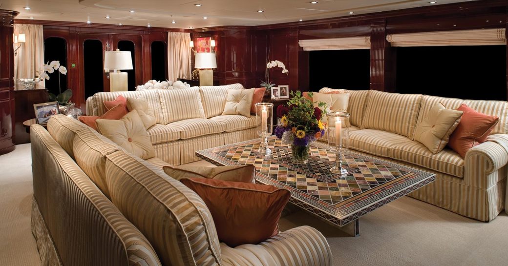 sumptuous sofas wrap around marble coffee table in main salon of motor yacht Lady Joy