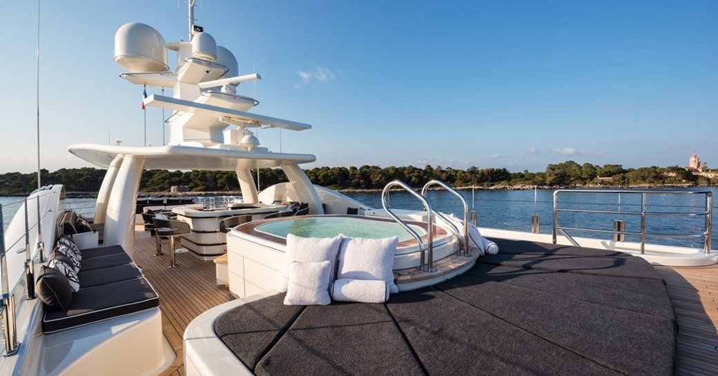 sunpads and Jacuzzi with bar beyond on sundeck of luxury yacht ELIXIR 