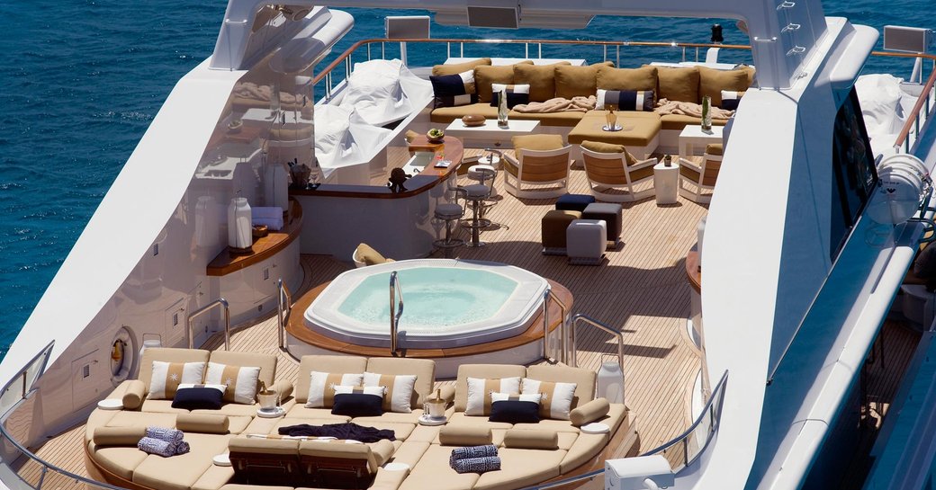 expansive sundeck with Jacuzzi, bar and sunpads on board superyacht HELIOS