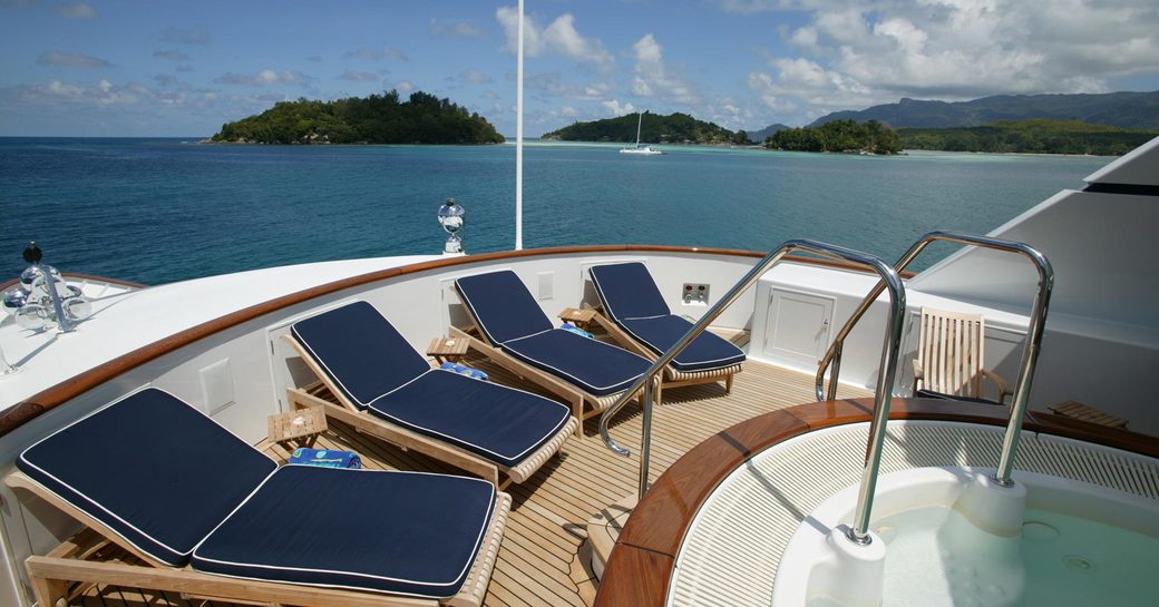 Jacuzzi and sun loungers on sun deck of superyacht TELEOST