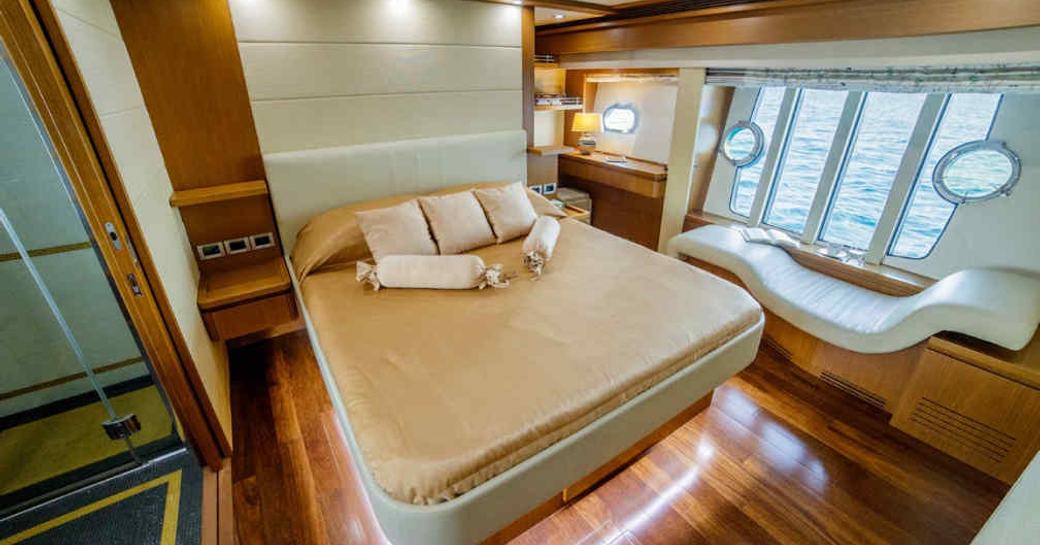 Master cabin onboard charter yacht ORLANDO L, central berth facing forward with large windows adjacent