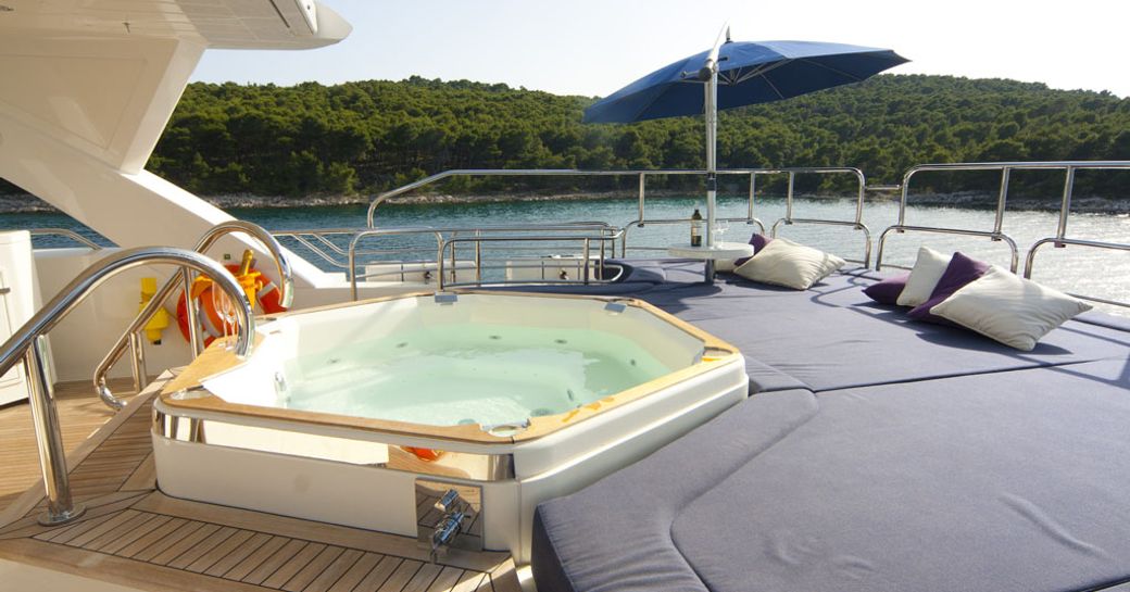 Jacuzzi pool and sunpads on luxury charter yacht CASSIOPEIA