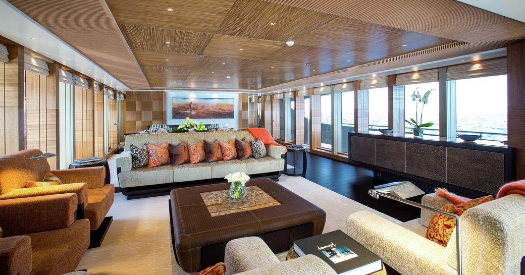 Australian outback-themed main salon with full-length windows on board superyacht RUYA 