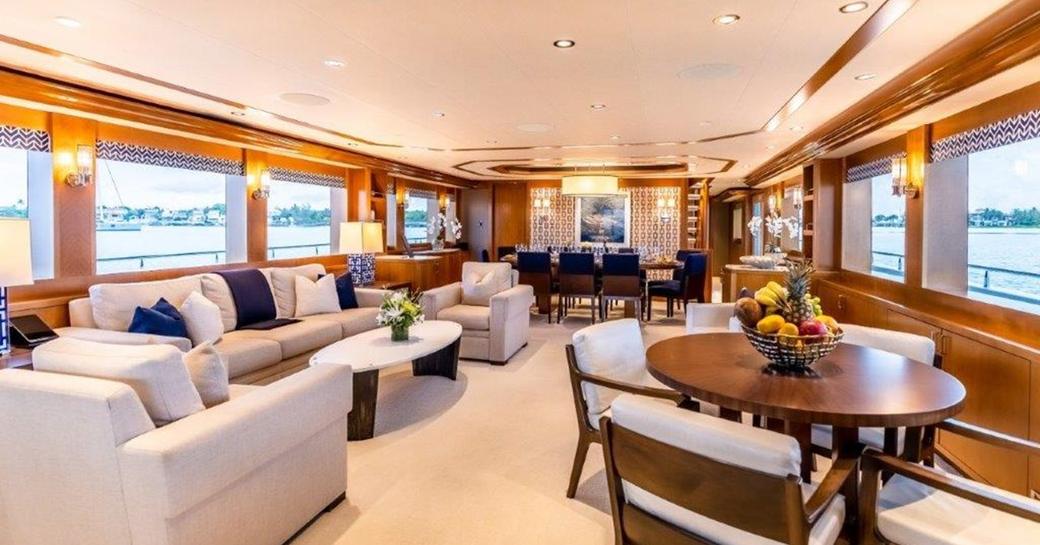 Overview of the main salon onboard charter yacht Far Niente, extensive lounge area with many windows to port and starboard