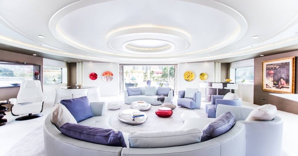 idyllic salon with curved lilac sofas aboard charter yacht SALUZI