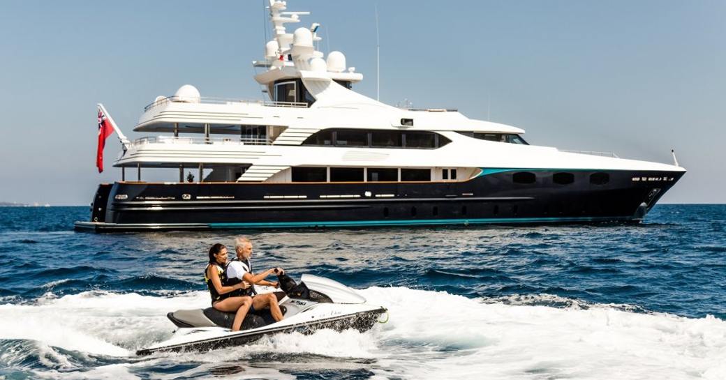 motor yacht ELENI at anchor as guests play on the jet ski 