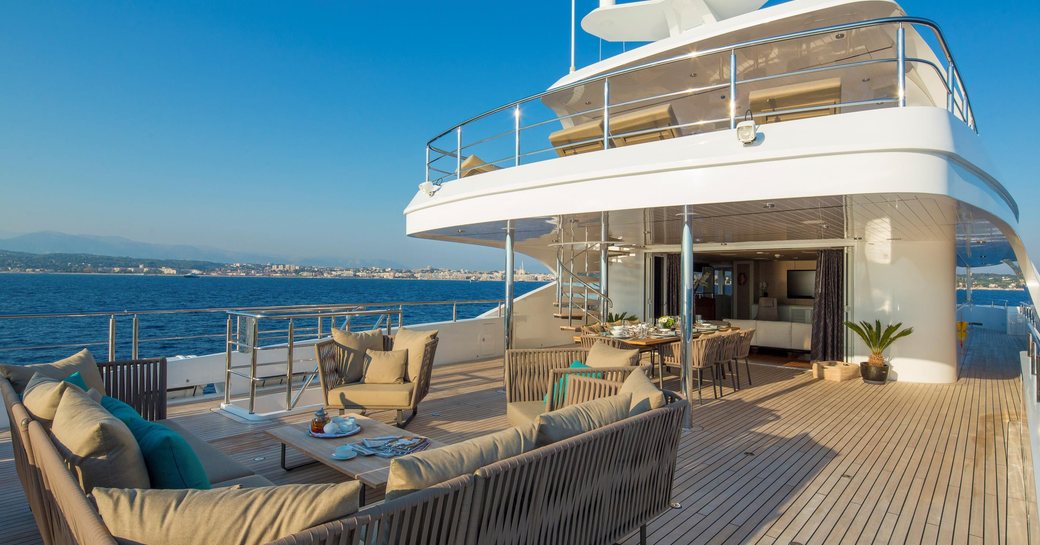 seating and dining areas on the upper deck aft of motor yacht Big Sky 