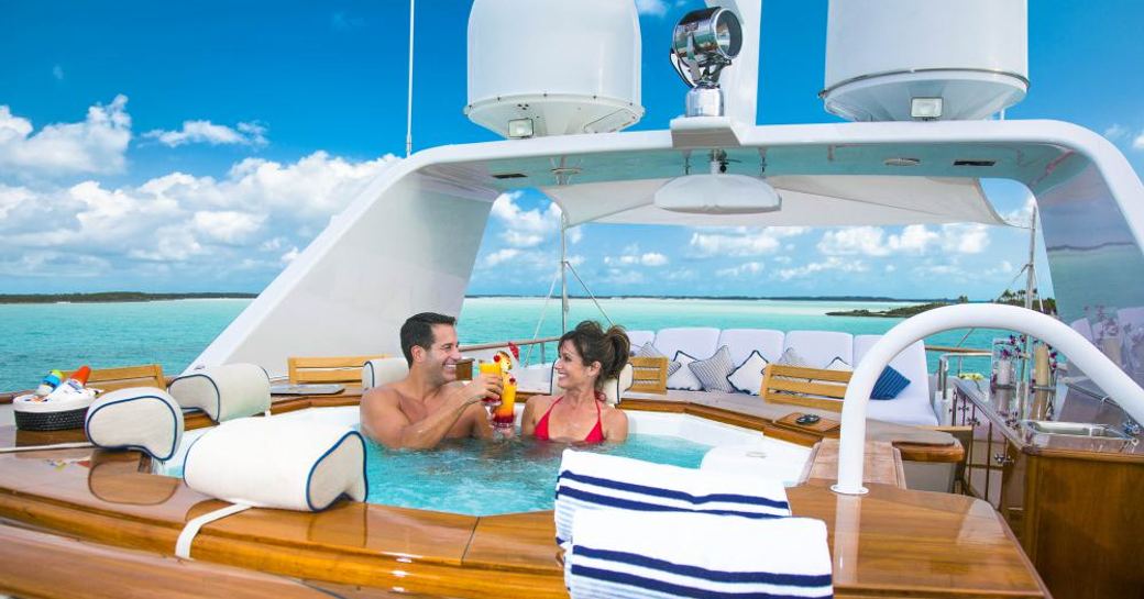 charter guests enjoy cocktails in Jacuzzi on board luxury yacht ‘Lady J’ 