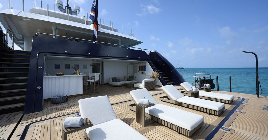 Swim platform onboard charter yacht ARBEMA, with four sun loungers and a beach club aft