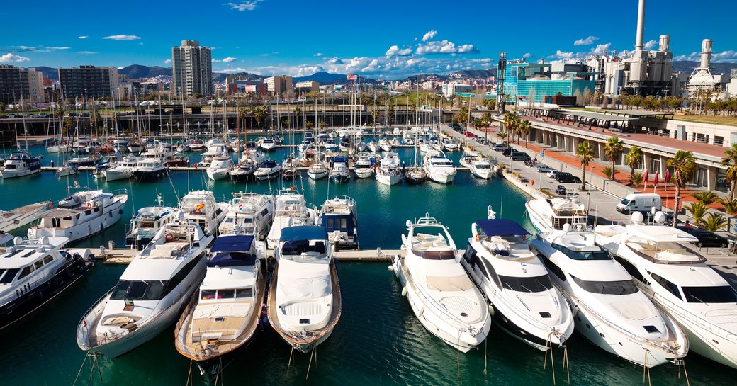 Motor yachts at anchor in marina in Spain