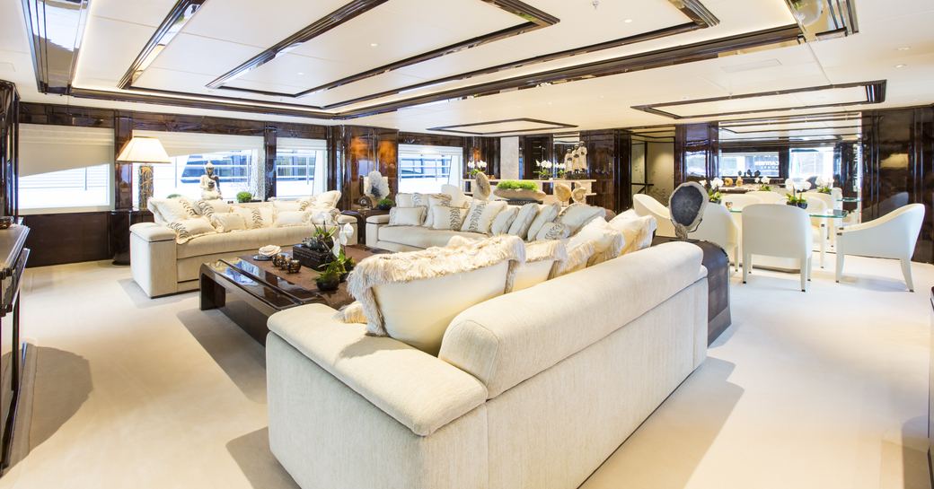 main salon with sumptuous sofa and formal dining area on board charter yacht ‘Illusion V’ 