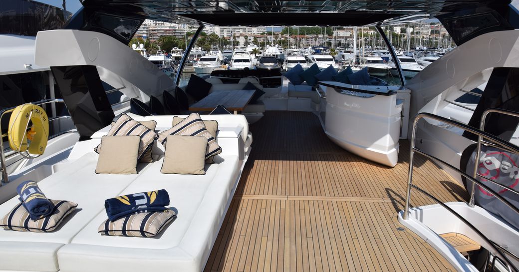 Flybridge of superyacht RAY III, with sun pads, bar and alfresco dining