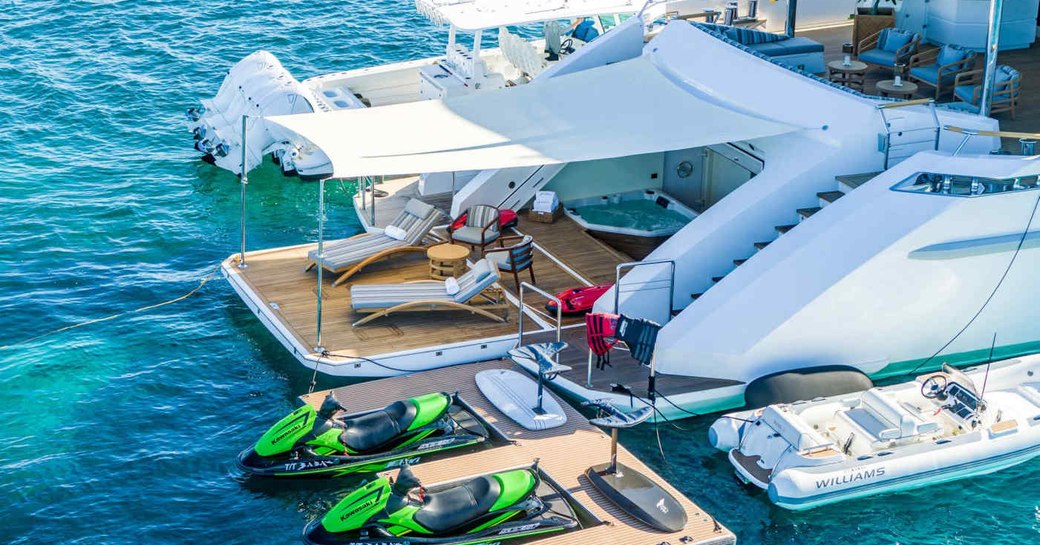 Overview of the beach club onboard Charter yacht BABAS with a mix of water toys adjacent and on the deck