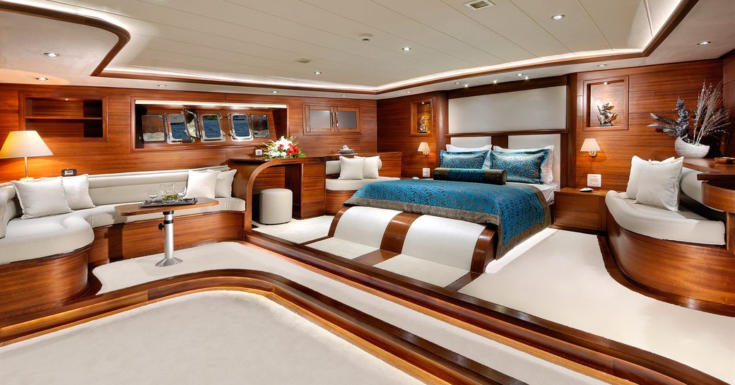Overview of the master cabin onboard sailing yacht charter ALESSANDRO I, central berth facing forward with seating area to port side
