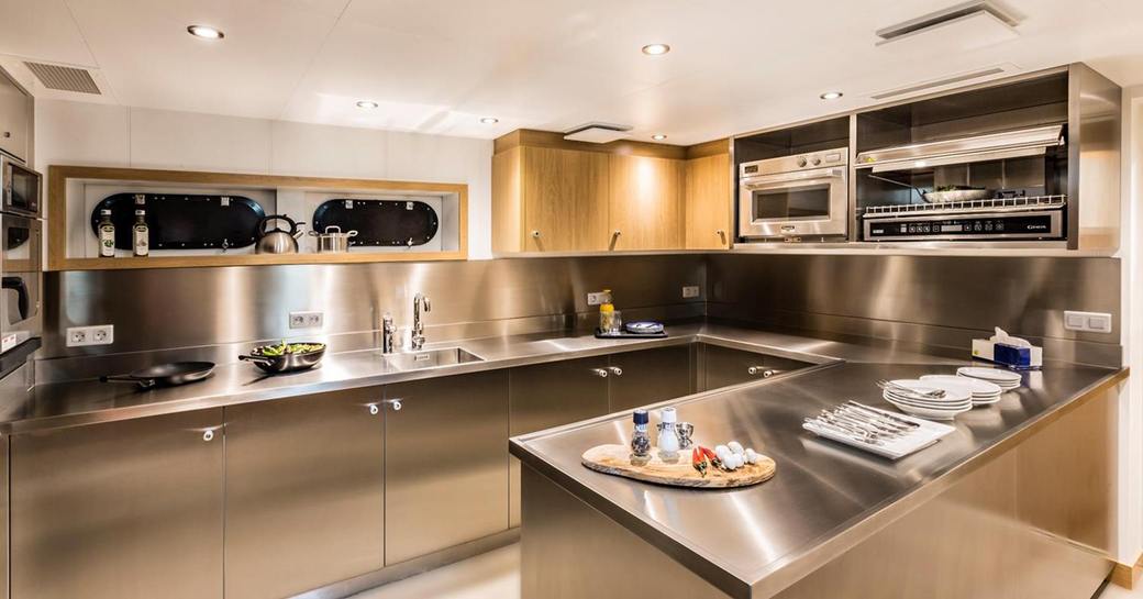 Stainless steel galley of Game Changer yacht with sinks and storage space
