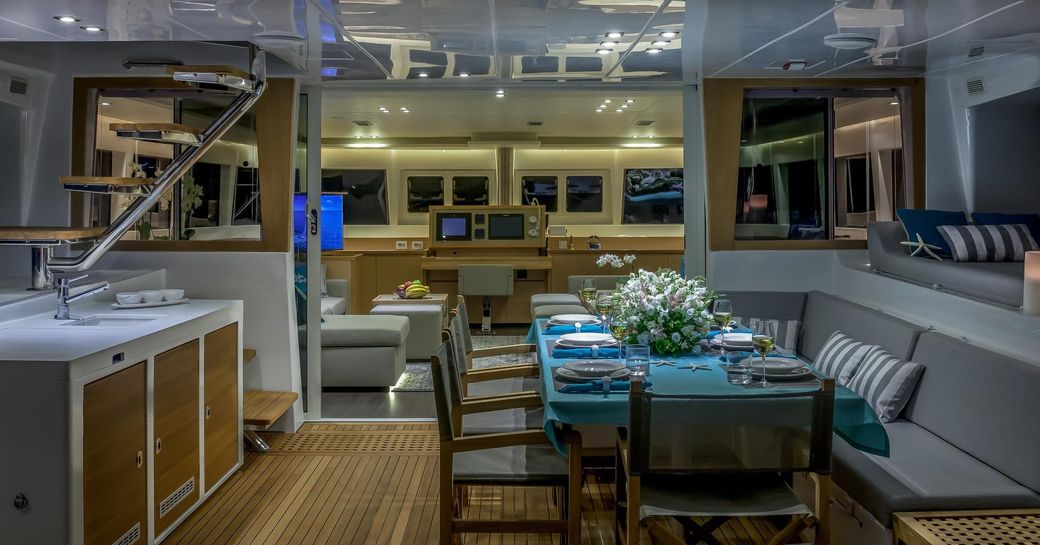 large dining table in the cockpit aboard luxury catamaran Ocean View 