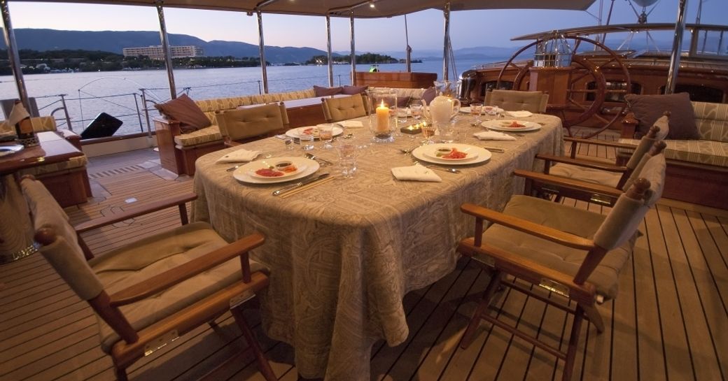 dining table in cockpit of sailing yacht ATHOS as the sun sets over the horizon