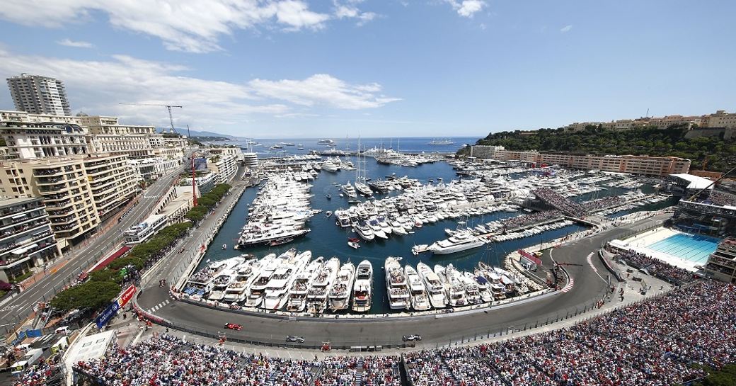 Monaco Grand Prix track curves round Port Hercules which is lined with superyachts