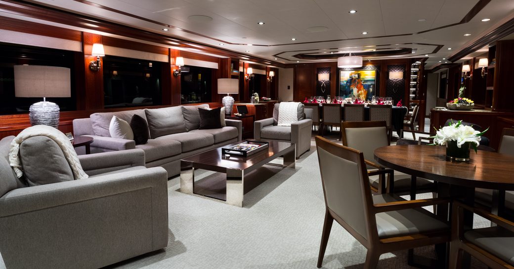 main salon with lounge and formal dining area beyond on board charter yacht W